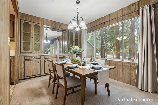a dining room with furniture a chandelier and a rug