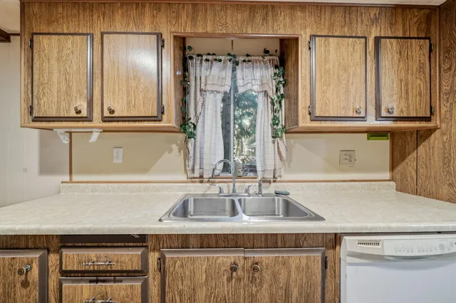 a kitchen with a sink and a refrigerator
