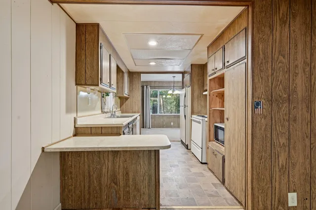 a hallway with a large window and couch