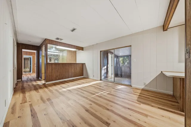 a view of empty room with wooden floor