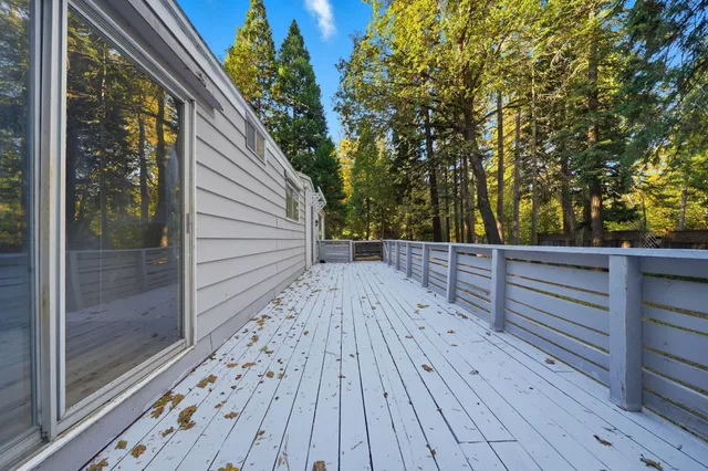 a view of balcony with wooden floor and fence