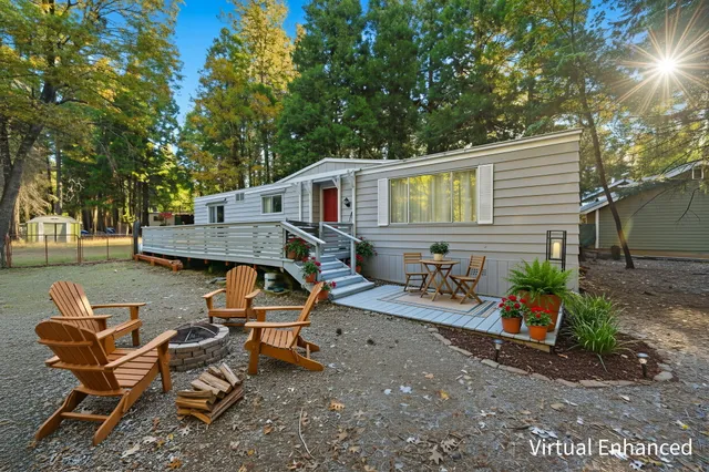 a view of a house with backyard and sitting area