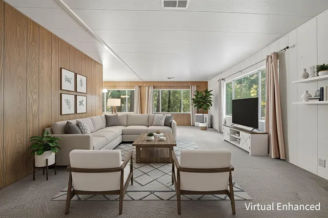 a living room with furniture wooden floor and a flat screen tv