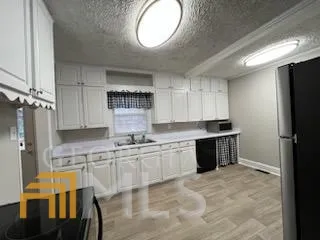 a kitchen with stainless steel appliances granite countertop a stove a refrigerator and a sink with wooden cabinets