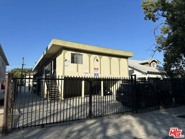 a view of a house with a wooden fence