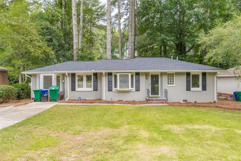 2347 Hunting Valley Drive Decatur, GA 30033 - Photo 1 of 1 a front view of a house with a garden and yard