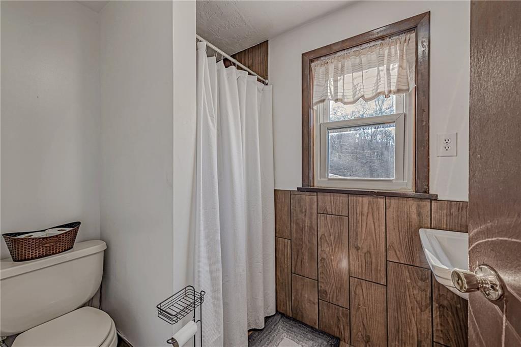 632 Hopewell Road White, PA 15490 - Photo 15 of 25 a bathroom with a toilet a sink and a window