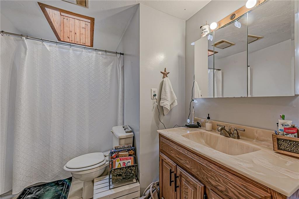 632 Hopewell Road White, PA 15490 - Photo 18 of 25 a bathroom with a sink a toilet and shower curtain