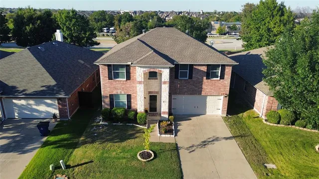 an aerial view of a house with yard