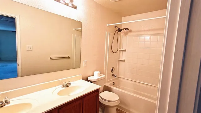 a bathroom with a sink toilet tub and shower