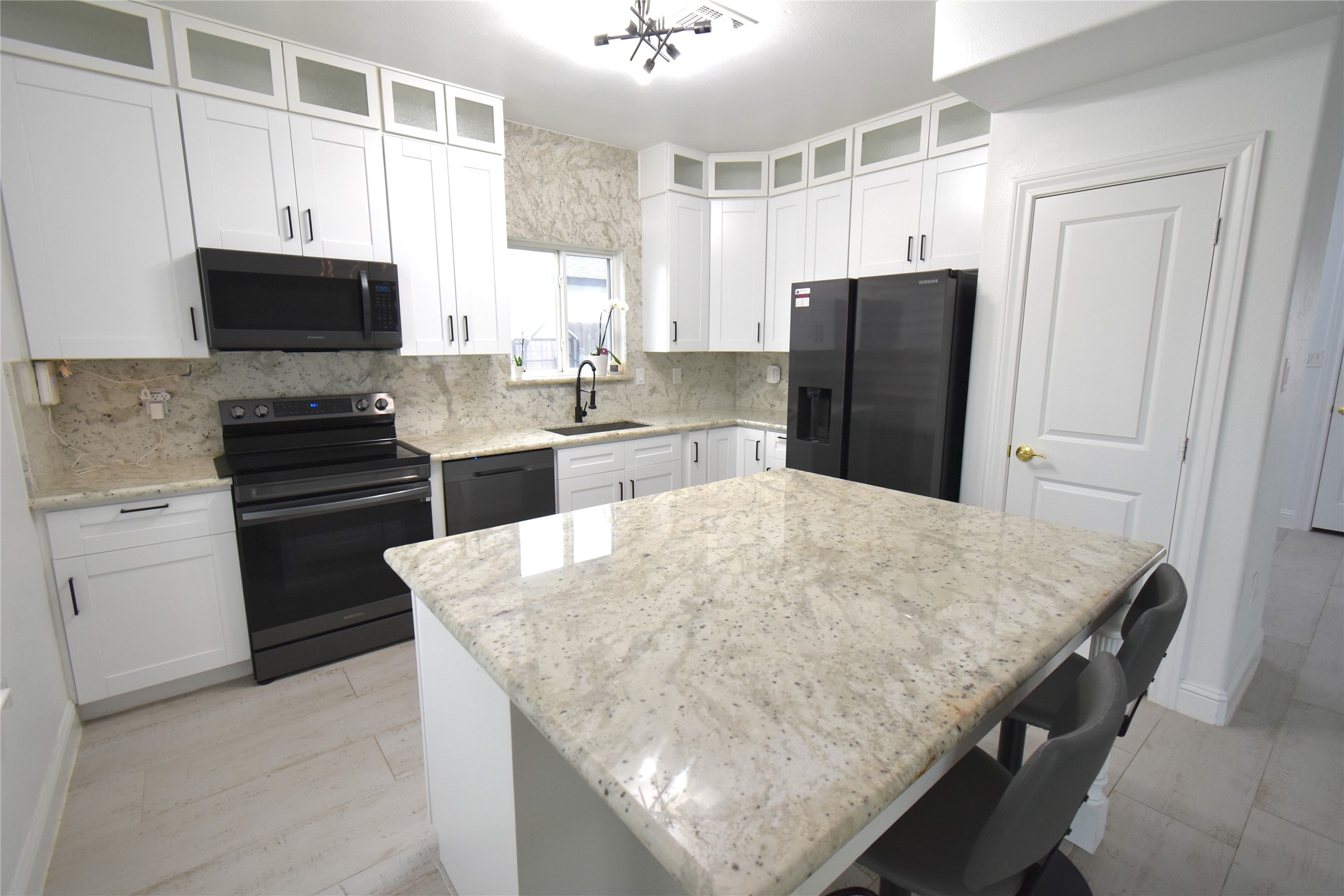 42 County Rd-5102L Cleveland, TX 77327 - Photo 2 of 9 a kitchen with kitchen island a counter top space appliances and cabinets