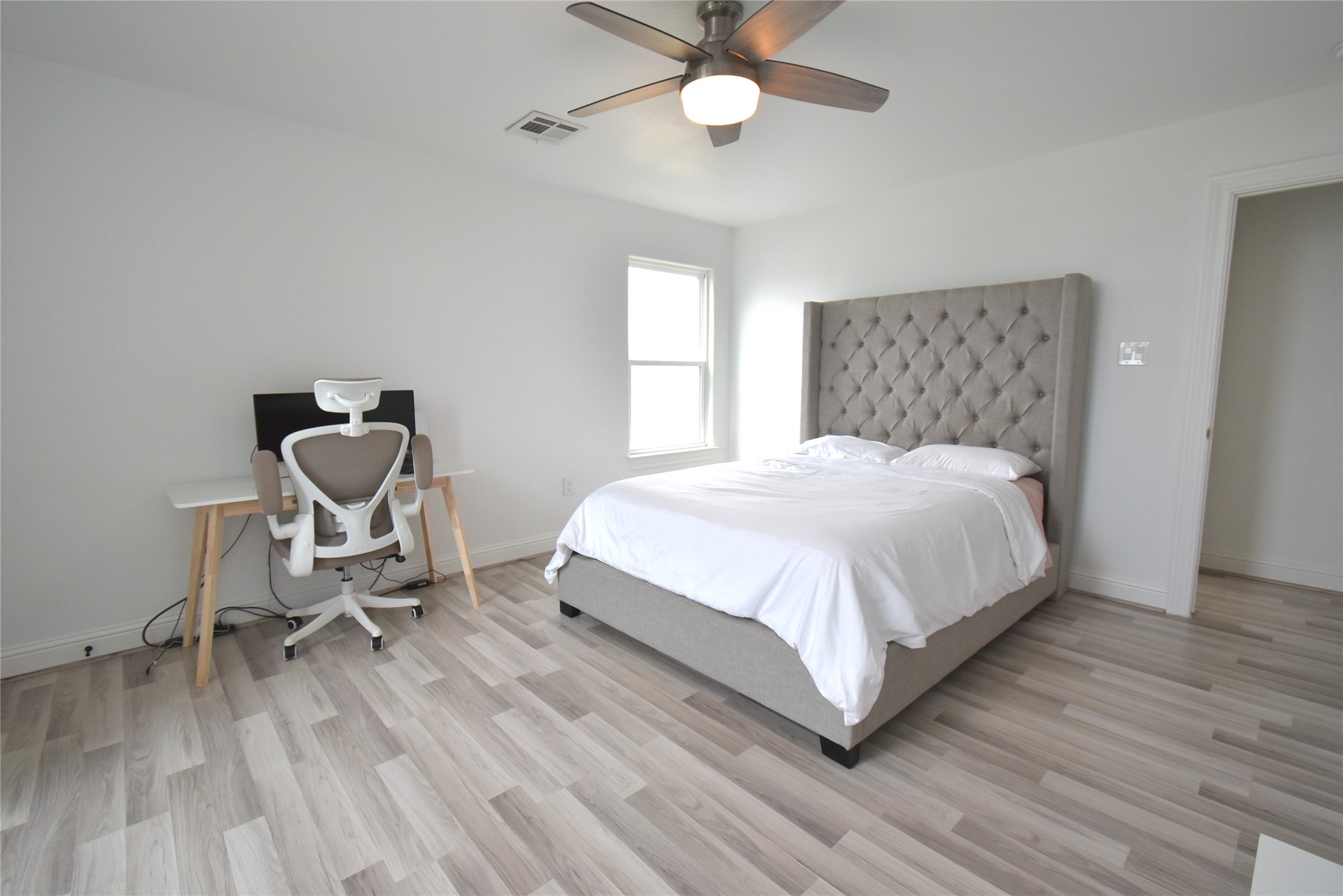 42 County Rd-5102L Cleveland, TX 77327 - Photo 9 of 9 a bedroom with a bed a chair and a chandelier