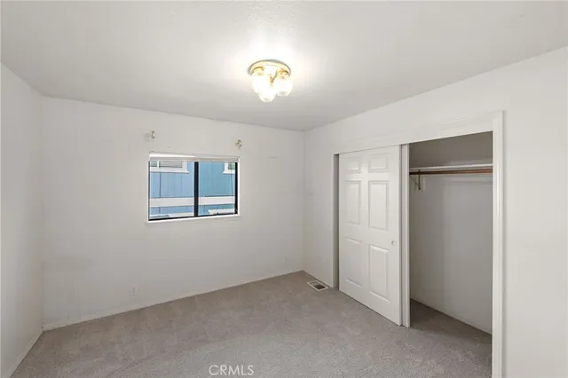 a bathroom with a sink a toilet a mirror and shower