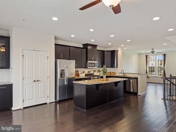 a kitchen with stainless steel appliances granite countertop a stove and a refrigerator