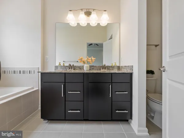 a bathroom with a sink vanity and a mirror