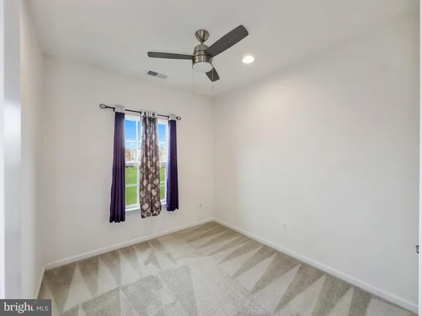an empty room with windows and closet