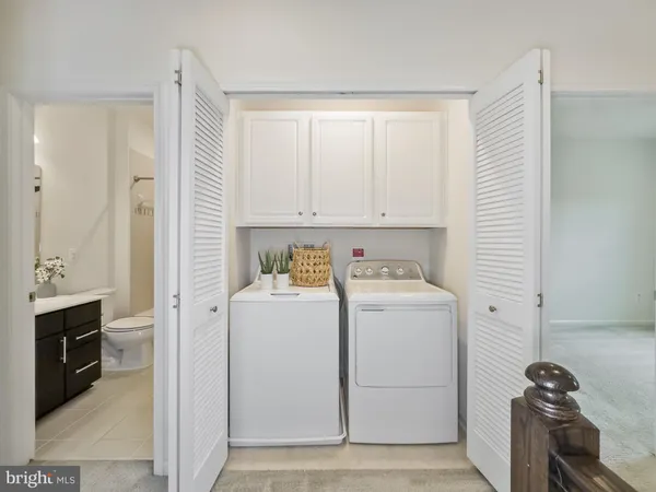 a view of storage and utility room with washer and dryer