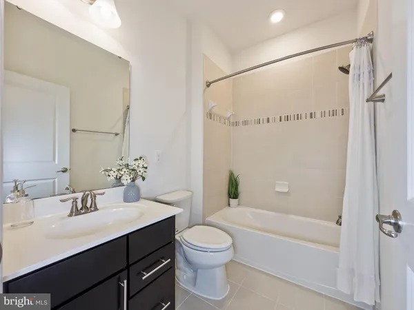 a bathroom with a granite countertop sink a toilet and shower