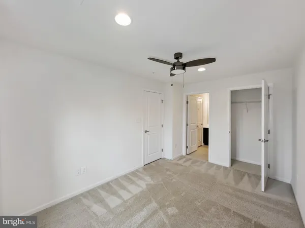 a view of a livingroom with a ceiling fan and entryway
