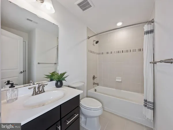 a bathroom with a sink vanity mirror and toilet