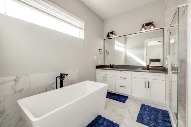 a bathroom with a granite countertop sink a toilet and shower