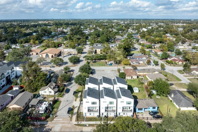 an aerial view of residential houses with outdoor space