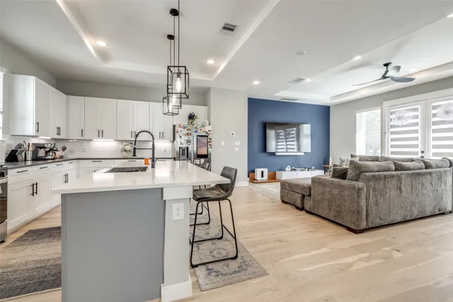 a living room with furniture a dining table and kitchen view