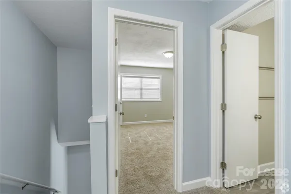 a view of a bathroom with a glass door and a mirror