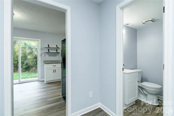 a bathroom with a toilet sink and a mirror