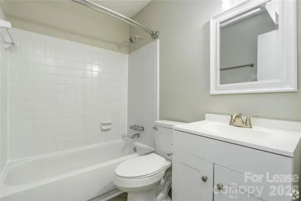 a bathroom with a sink toilet vanity and tub
