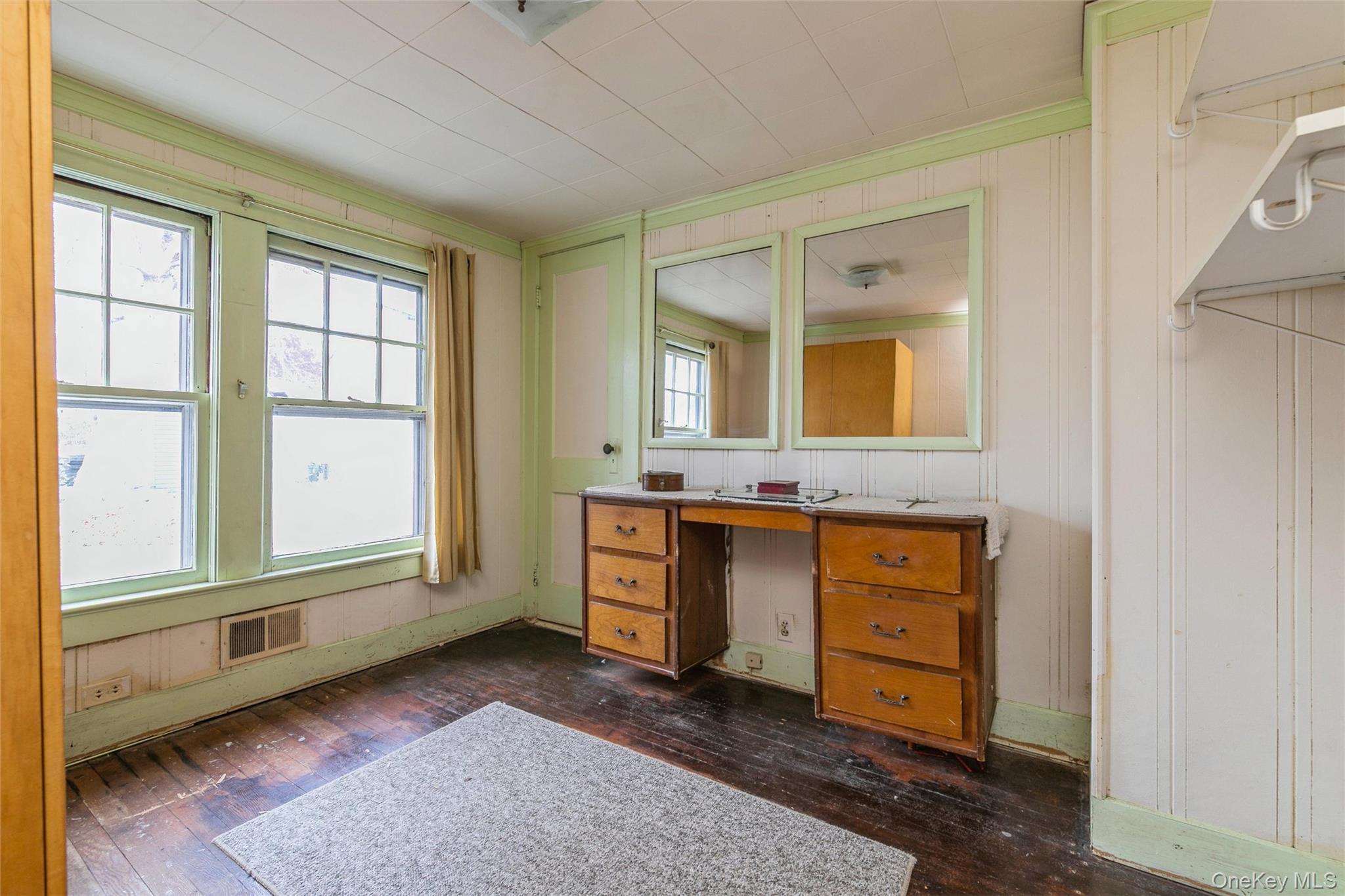 84 Riviera Drive Mastic, NY 11950 - Photo 13 of 28 Bathroom featuring dark wood-style flooring, vanity, crown molding, and wood walls