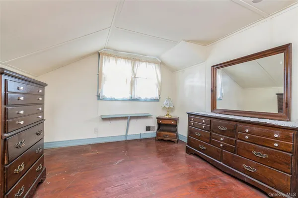 a room with a dresser and a mirror