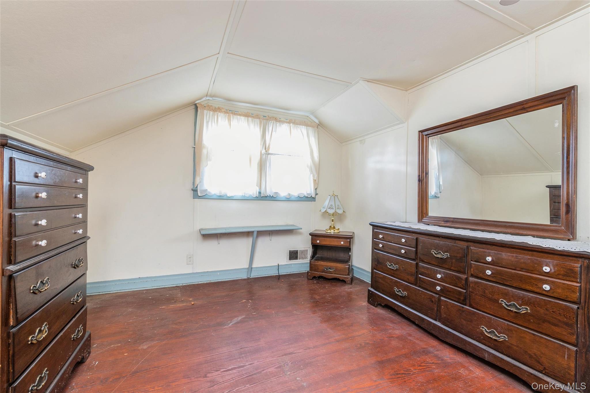 84 Riviera Drive Mastic, NY 11950 - Photo 17 of 28 Bedroom featuring dark wood-style flooring and vaulted ceiling