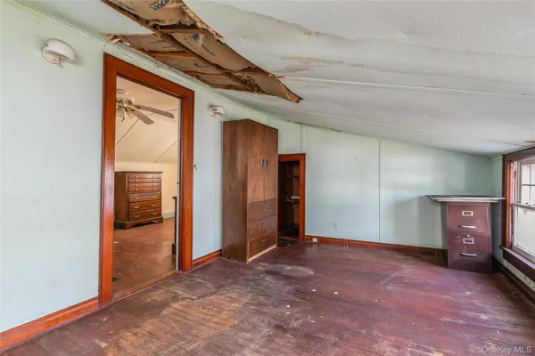 a view of a hallway with wooden shelves