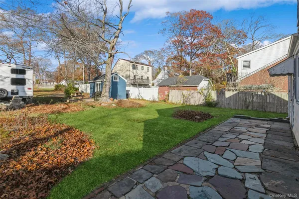 a view of a yard with a house in the background