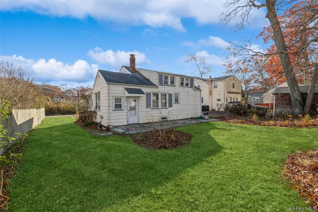 a view of a house with a backyard