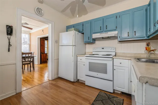 a kitchen with a white cabinets and white appliances