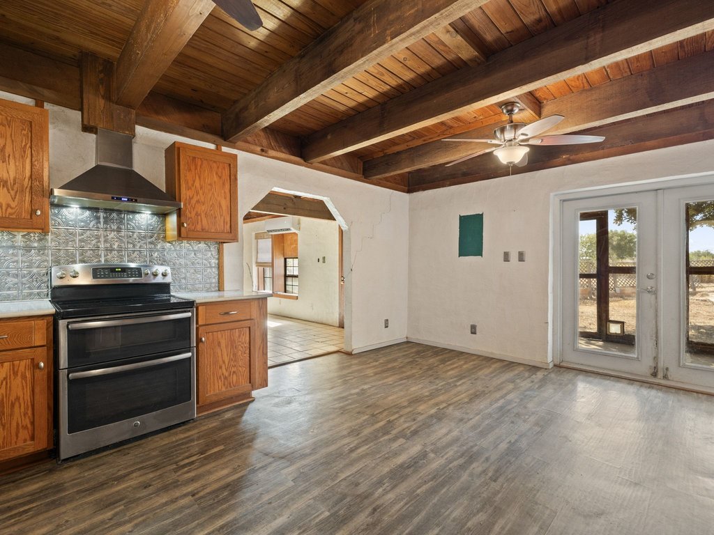 20416 Wilson Road Coupland, TX 78615 - Photo 18 of 39 Rich wood plank ceilings and exposed beams crown this open kitchen and dining area.