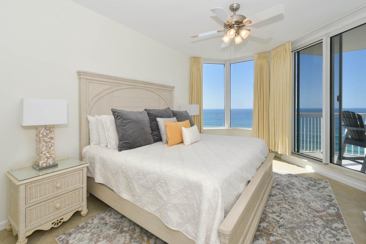 1050 Highway 98, Unit 905E Destin, FL 32541 - Photo 13 of 30 a bedroom with a bed and a chandelier