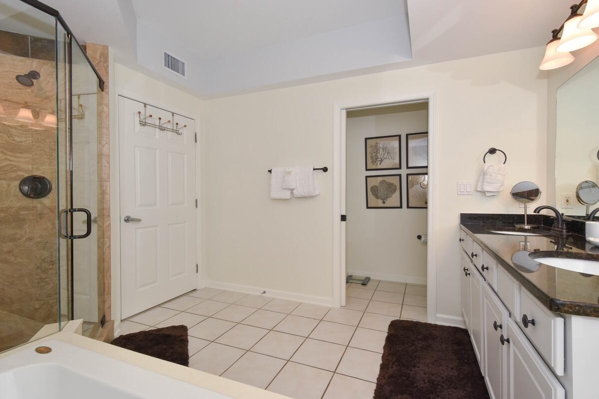 1050 Highway 98, Unit 905E Destin, FL 32541 - Photo 14 of 30 a bathroom with a sink a toilet and shower
