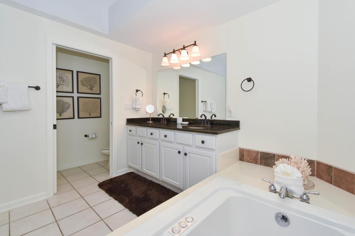1050 Highway 98, Unit 905E Destin, FL 32541 - Photo 15 of 30 a bathroom with a sink a mirror and a shower
