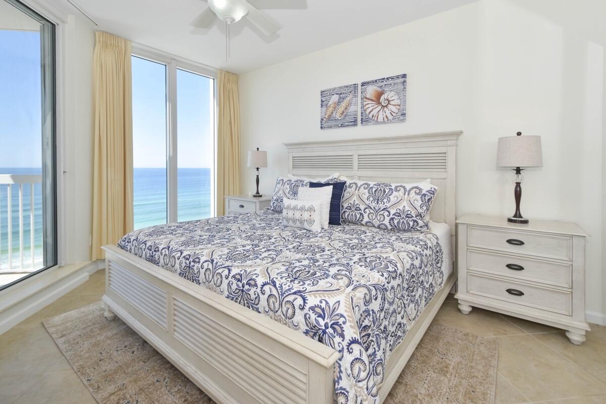 1050 Highway 98, Unit 905E Destin, FL 32541 - Photo 16 of 30 a bedroom with a bed and a chandelier