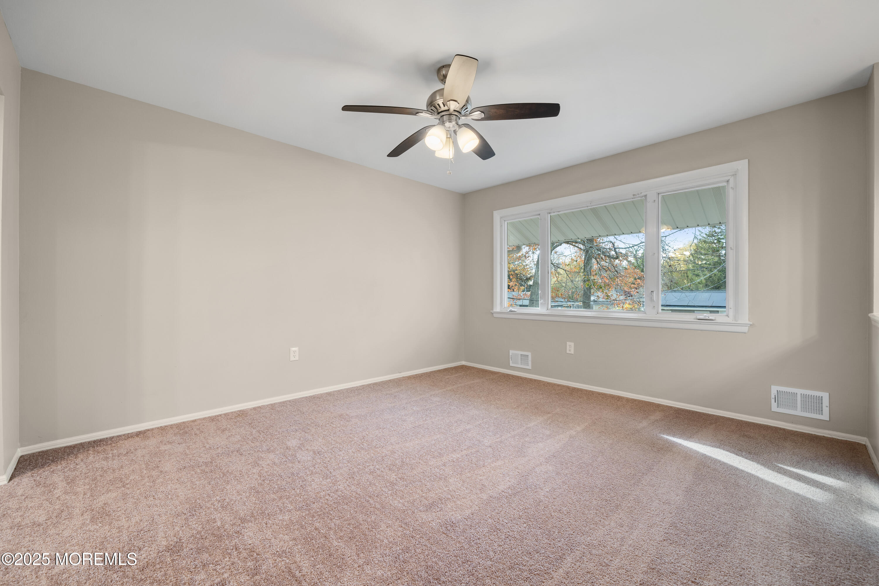 137 Red Bank Avenue Bayville, NJ 08721 - Photo 11 of 24 an empty room with window and ceiling fan