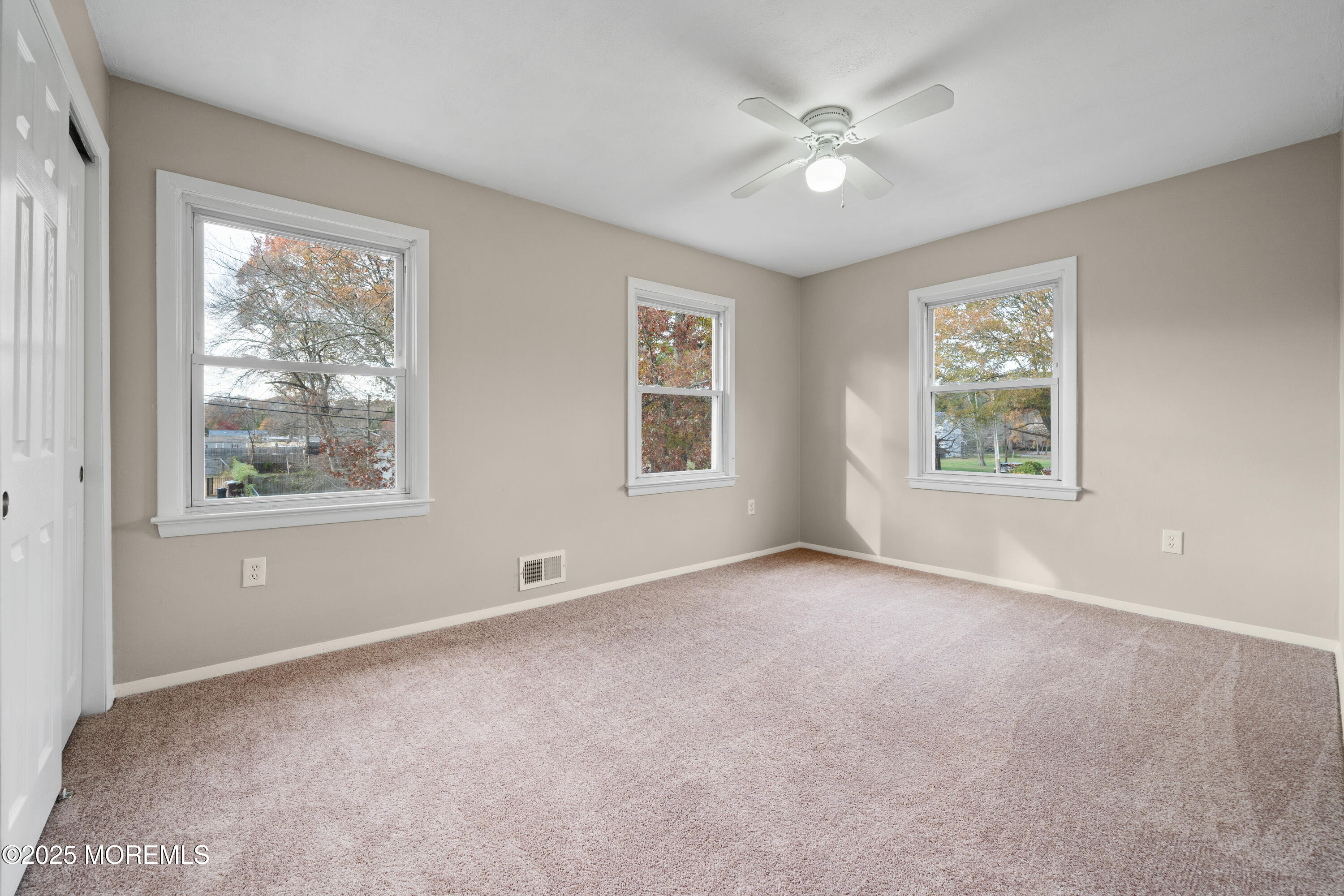 137 Red Bank Avenue Bayville, NJ 08721 - Photo 20 of 24 an empty room with windows and ceiling fan