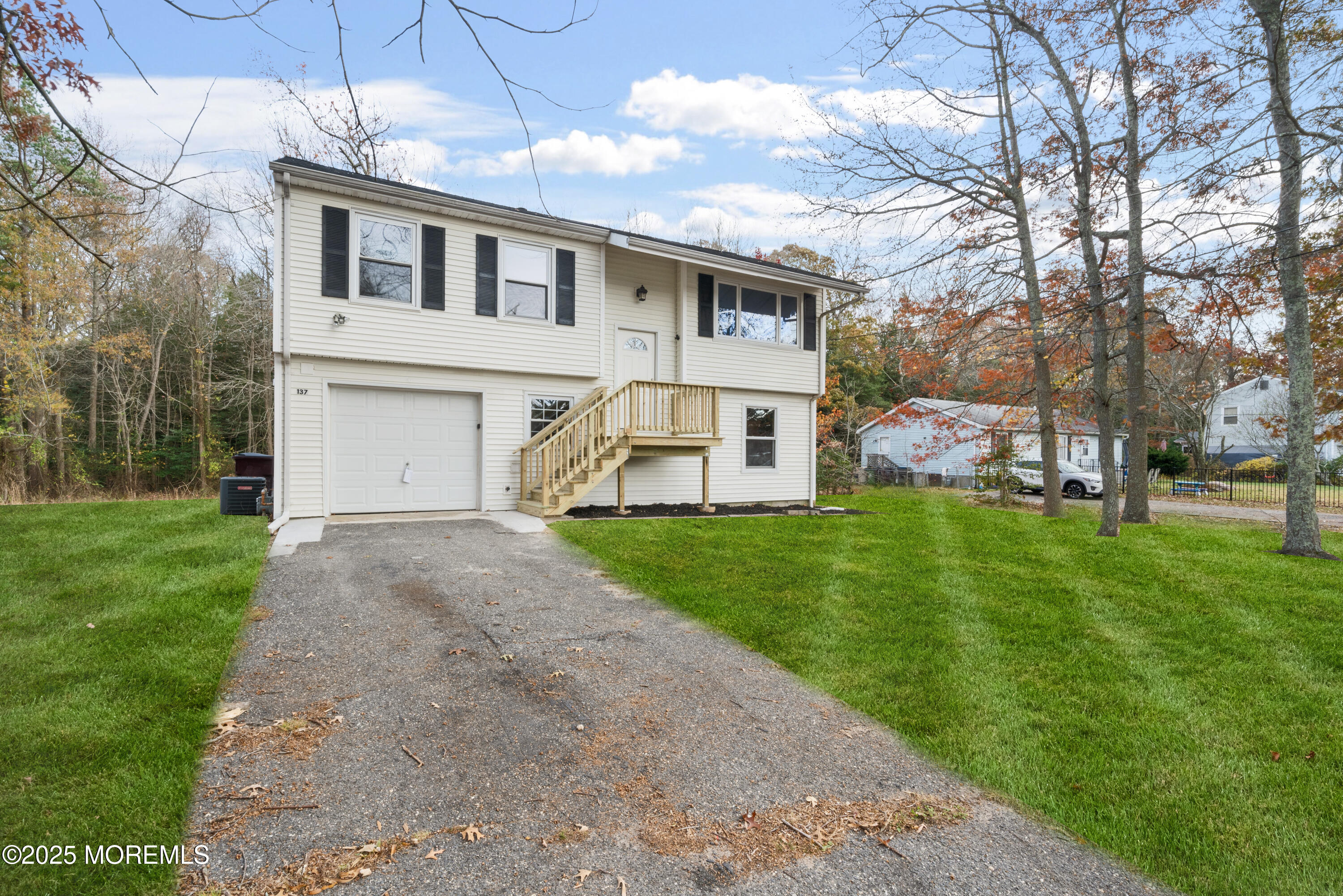 137 Red Bank Avenue Bayville, NJ 08721 - Photo 2 of 24 a front view of a house with a yard and trees