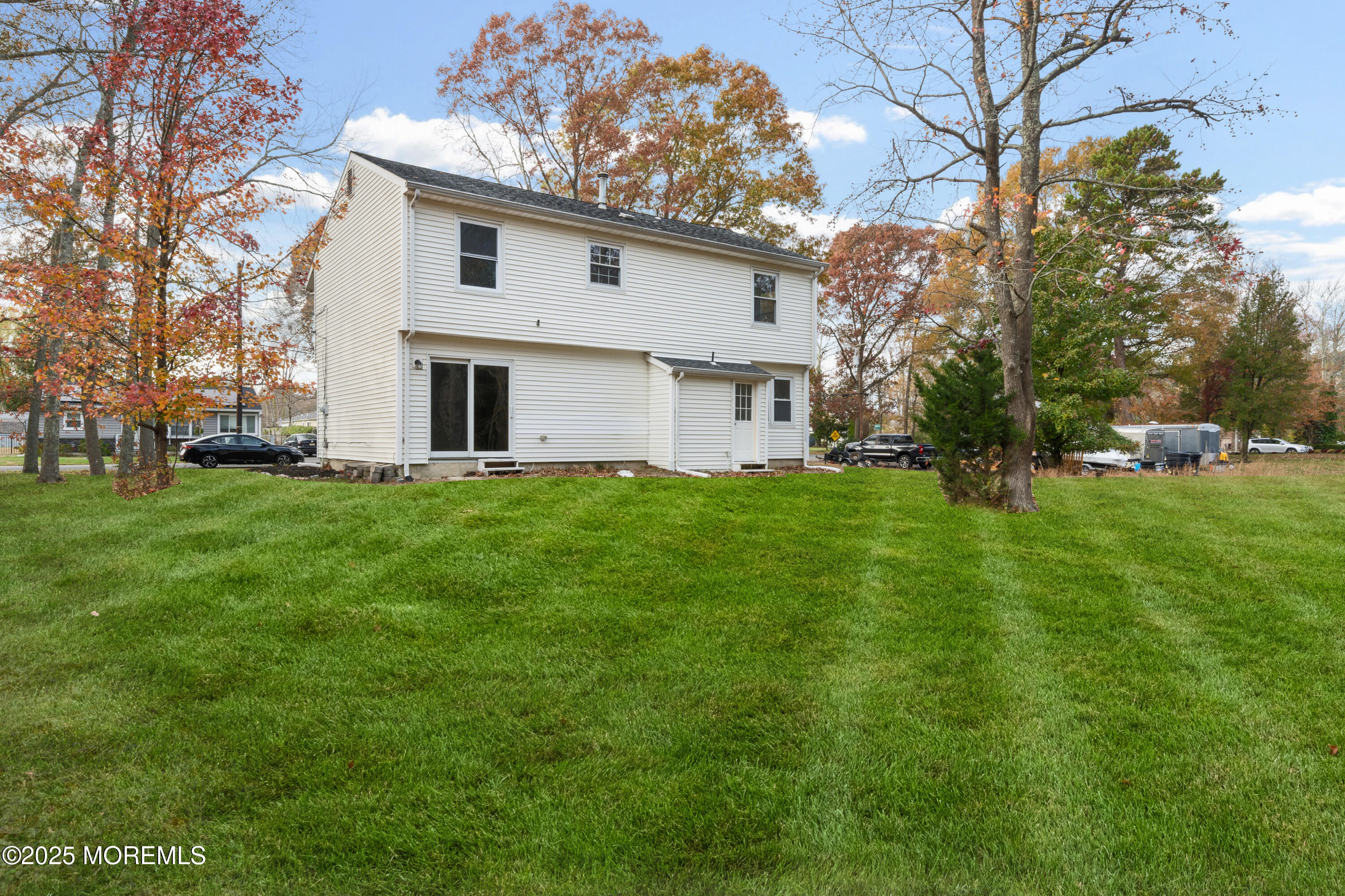 137 Red Bank Avenue Bayville, NJ 08721 - Photo 4 of 24 a white house with a big yard and large trees