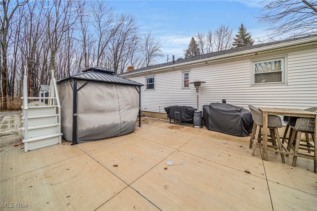 6600 Reynolds Road Mentor, OH 44060 - Photo 30 of 35 Wooden terrace with area for grilling, a gazebo, and an outdoor bar