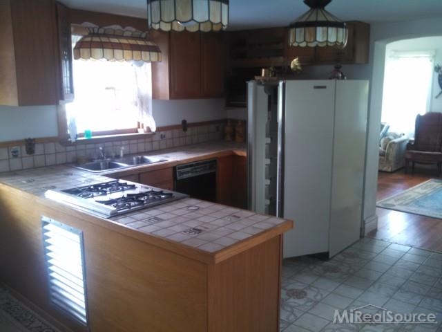 7663 Avoca Road Avoca, MI 48006 - Photo 2 of 23 This is a view of the kitchen.