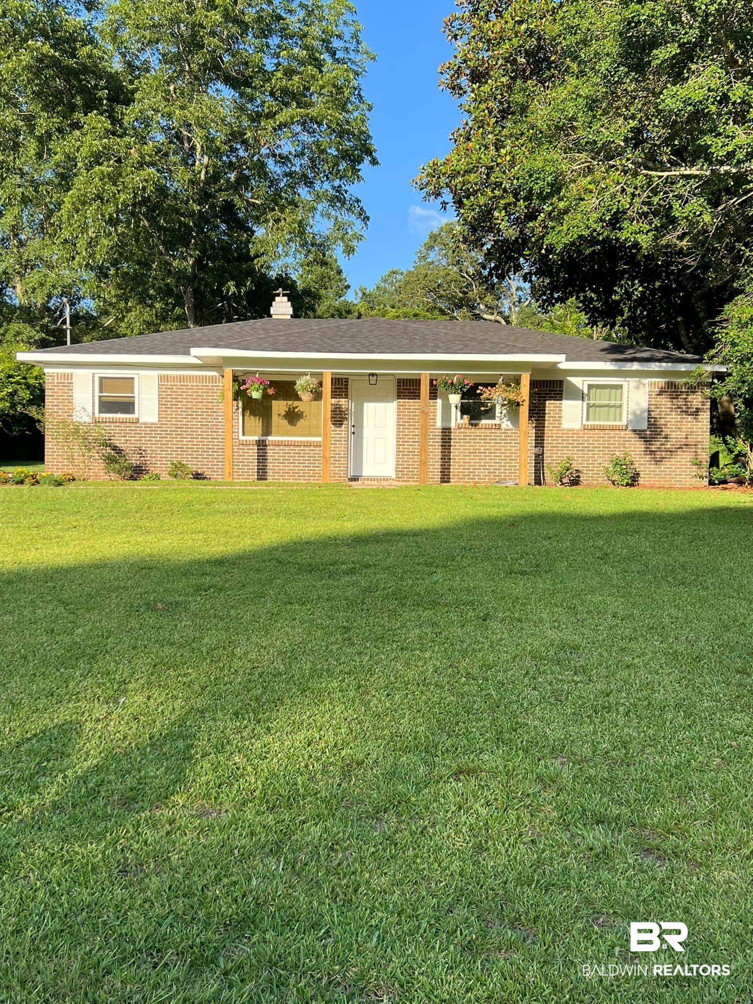 90 Florida Street Monroeville, AL 36460 - Photo 29 of 31 Ranch-style house featuring a front yard in the summer