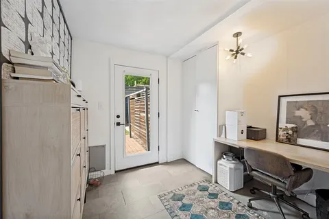a view of a livingroom with furniture and a window